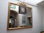 Large Louis Philippe mirror with clock Complete gelatin and mordant regilding of a large Louis Philippe mirror with clock